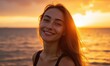 © Alex - Smiling woman at sunset by the ocean