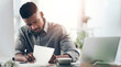 © Nicholas F/peopleimages.com - Laptop, notebook and writing with business black man at desk in office for planning or review. Computer, journal and notes with professional employee in workplace for information or research