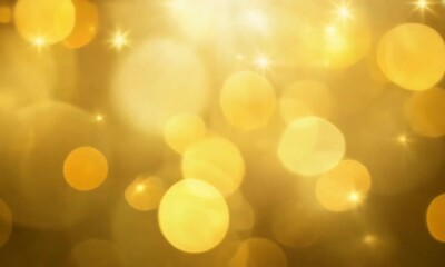 Wall Mural - yellow blurred lights and sparkling particles create a glowing, magical 4k background. perfect for f