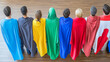 © PPS - A diverse group of people stand back to back wearing colorful capes, signifying teamwork and unity.
