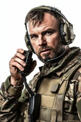 Soldier in camouflage uniform uses a radio.