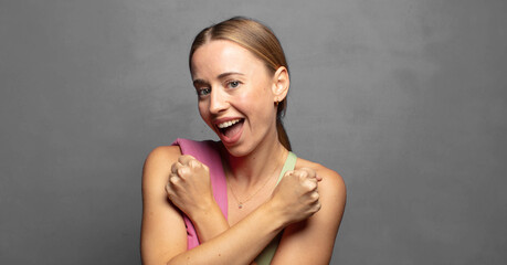 Canvas Print - smiling cheerfully and celebrating, with fists clenched and arms crossed, feeling happy and positive