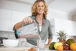 © peopleimages.com - Hands, blender and glass in kitchen for wellness with fruit, nutrition and meal prep for smoothie in morning. Person, drink and breakfast with ingredients for diet, gut health and recipe in home