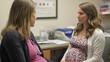 © twentyone - pregnant woman consults with healthcare professional in office