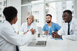 © peopleimages.com - Doctor, team and happy with meeting in boardroom for healthcare diagnosis, surgery planning and medical workshop. Medicine, professional and nurse with technology for health assessment and treatment