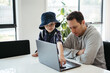 © Austockphoto - Dad helping kids with their homework using laptop