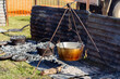 © Austockphoto - camp oven cooking damper bread on fire coals shielded by corrugated iron