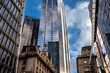 © yaqui_villegas - The image showcases a city scene where tall, reflective skyscrapers tower above a historic building, highlighting the intersection of modern innovation and classic architecture  in London UK