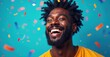 © Vancouver - a smiling black man with a beard and colorful confetti