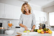 © peopleimages.com - Woman, knife and fruit in kitchen for portrait with apple, nutrition and meal prep for smoothie in morning. Person, chef and chopping board with ingredients for diet, gut health and home in France