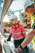 © Austockphoto - A contractor teaching a young apprentice how to use the level on worksite