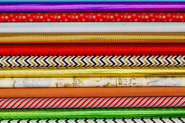 Aufkleber - Many different colorful wrapping paper rolls. Holiday gift wrapping papers background