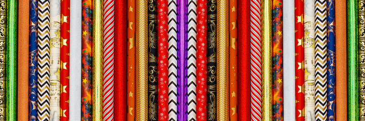 Poster - Many different colorful wrapping paper rolls. Holiday gift wrapping papers banner background