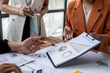 © Wasana - Business people analyzing financial business chart using calculator and laptop for calculation tax and budget