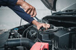 © Nonthanat - Mechanic using wrench while working on car engine outside the service center , Repair and service.