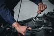 © Nonthanat - Mechanic using wrench while working on car engine outside the service center , Repair and service.
