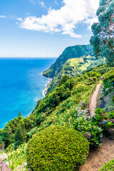 Wall Mural - A view south along the cliff path from the viewpoint at Sossego on the island of Sao Miguel in the Azores in summertime