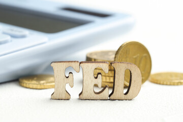 Poster - Word Fed (Federal Reserve System) made with letters and coins on wooden table