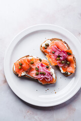 Canvas Print - Salmon toast with cream cheese, pickled red onion and capers.