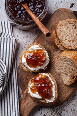 Canvas Print - Onion jam on toast with cream cheese, gray background.