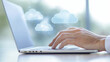 © Tania - Hands Typing on Laptop with Hologram Icons of Cloud Services and Syncing