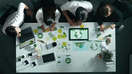 Top view of executive manager hold tablet display clean energy at meeting. Aerial view of business people working together to plan and invest in sustainable environmental investment. Alimentation.