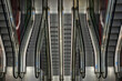 © yaqui_villegas - A captivating image showcasing the symmetry of modern escalators, mirroring each other in a well-lit setting, representing progress and urban architecture.