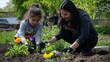 © dominic - Mother and Daughter Planting Flowers in Garden