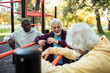 © Marko Geber - Senior men socializing and relaxing at outdoor park fitness area