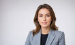 © Miklos - A woman with long brown hair smiles at the camera while wearing a blue blazer in front of a white background
