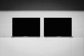 Wall Mural - scene with an open laptop with a blank screen on a concrete background