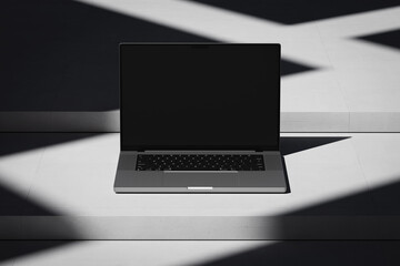 Wall Mural - Scene with an open laptop with a blank screen on a concrete background