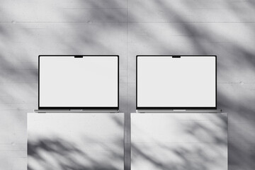 Wall Mural - scene with an open laptop with a blank white screen on a concrete background