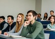 © Rizka - Students in a lecture hall listening attentively.