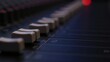 © useful pictures - A detailed view of knobs and sliders on an audio mixing console, showcasing the intricate controls used during music production in a recording studio