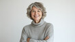 © Michael - Cheerful mature woman with crossed arms, gray hair, and a turtleneck sweater exuding confidence and positivity in her portrait