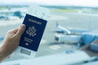 © kieferpix - Passenger at airport holding USA passport ready to travel