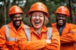 © Konstiantyn Zap - Joyful construction workers in orange safety gear laugh together outdoors
