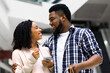 © Prostock-studio - Young Black Shopaholic Couple Using Discount App While Shopping In Mall, Standing With Smartphone And Bright Shopper Bags In Modern Department Store, Enjoying Seasonal Sales, Copy Space