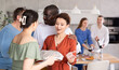 © JackF - Friends and couples greet each other and give gifts before the festive dinner at a house party