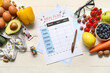 © Pixel-Shot - Blank meal plan and health food on table