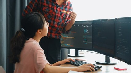 Slow motion back end or software developer manager supervising his team on new application program development on debugging and solving complex code algorithms on monitor. Burgeoning