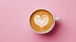 © Seyyar - Romantic coffee moment latte art heart on a pink background viewed from above Cappuccino with heart design captured in a top down perspective on a pink surface