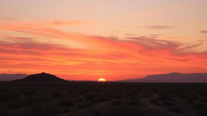 Wall Mural - vibrant orange and pink hues of a desert sunset casting a warm glow over the landscape, arid, peacef