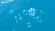 © Guadalupe - Bubbles and seething water in the light of sunlight.Blue water texture.