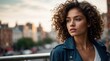 © VistaVisions - Portrait of young stylish happy woman with curly hair sunny outdoor in the urban city