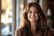 © Aashutosh Pandit - Smiling woman with long wavy hair in a cozy sweater