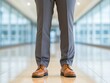 © Saranpong - Business attire featuring brown shoes and gray trousers.