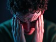 © Aashutosh Pandit - Distressed person with hands on head in dark moody lighting
