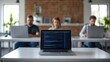 © GreenMOM - Focused professionals work on laptops in a modern office, showcasing teamwork and concentration in a collaborative environment.